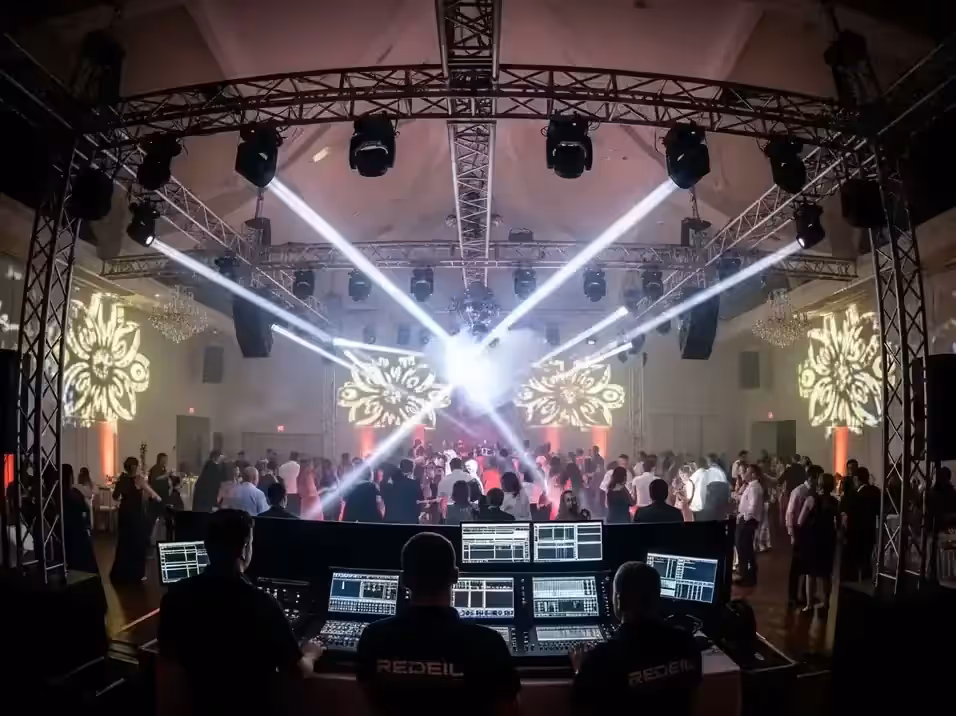 Operador con consola DMX controlando cabezas móviles en evento